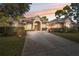 Stunning single-story home with mature landscaping and a long concrete driveway on a well-manicured lawn at 5351 Championship Cup Ln, Spring Hill, FL 34609