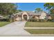 Attractive one-story home with a neatly kept yard, a driveway leading to a spacious attached garage at 5351 Championship Cup Ln, Spring Hill, FL 34609