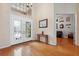 Inviting foyer with hardwood floors, a decorative glass front door, and a view into the living area at 5351 Championship Cup Ln, Spring Hill, FL 34609