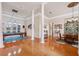 Bright and open game room with hardwood floors, a pool table, and a dining area at 5351 Championship Cup Ln, Spring Hill, FL 34609
