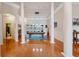 Expansive game room with hardwood floors, tray ceilings, columns, and a stylish pool table at 5351 Championship Cup Ln, Spring Hill, FL 34609