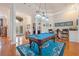 Elegant game room featuring hardwood floors, a pool table, and views of the front entrance at 5351 Championship Cup Ln, Spring Hill, FL 34609
