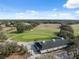 Aerial view highlighting the golf course grounds and clubhouse nestled in a scenic landscape at 5351 Championship Cup Ln, Spring Hill, FL 34609