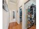Hallway featuring hardwood floors, storage shelves, and access to the bathroom at 5351 Championship Cup Ln, Spring Hill, FL 34609