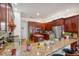 Spacious kitchen featuring granite counters, wood cabinets, stainless appliances, and island at 5351 Championship Cup Ln, Spring Hill, FL 34609
