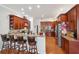 Spacious kitchen with breakfast bar seating, rich wood cabinets, and modern appliances at 5351 Championship Cup Ln, Spring Hill, FL 34609