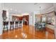 View of kitchen and breakfast nook featuring wood floors and natural lighting at 5351 Championship Cup Ln, Spring Hill, FL 34609