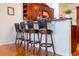 Kitchen bar featuring four seats, hardwood floor, and granite countertop at 5351 Championship Cup Ln, Spring Hill, FL 34609