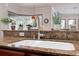 Kitchen sink with granite countertops, stainless steel faucet, and view from bay window at 5351 Championship Cup Ln, Spring Hill, FL 34609