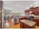 Open kitchen layout with stainless steel appliances, center island, and a view into the living area at 5351 Championship Cup Ln, Spring Hill, FL 34609