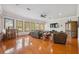 Spacious living room with wood floors, a ceiling fan, recessed lighting, and plenty of natural light at 5351 Championship Cup Ln, Spring Hill, FL 34609