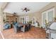 Spacious covered patio features dining and seating area with a mini fridge and grill at 5351 Championship Cup Ln, Spring Hill, FL 34609