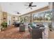 Outdoor entertaining area with lounge and dining space with views of the screened in pool at 5351 Championship Cup Ln, Spring Hill, FL 34609