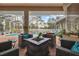 Cozy outdoor seating area with fire pit overlooking the screened-in pool and yard at 5351 Championship Cup Ln, Spring Hill, FL 34609