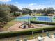 Community playground with slides, climbing features, and picnic tables, surrounded by lush greenery at 5351 Championship Cup Ln, Spring Hill, FL 34609