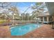 Relaxing pool area, perfect for outdoor enjoyment, surrounded by lush landscaping at 5351 Championship Cup Ln, Spring Hill, FL 34609