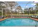 Sparkling pool offers a refreshing retreat with views of the well-manicured backyard and golf course at 5351 Championship Cup Ln, Spring Hill, FL 34609