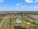 Beautiful aerial view of the community with pool, lakes, landscaping, and road access on a sunny day at 5412 Hammock View Ln, Apollo Beach, FL 33572