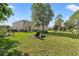 Extensive backyard with a fire pit, patio dining, and meticulous landscaping, ideal for outdoor activities and relaxation at 5412 Hammock View Ln, Apollo Beach, FL 33572