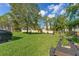 Lush backyard with a fire pit area, hammock, and meticulously kept lawn, perfect for outdoor enjoyment and relaxation at 5412 Hammock View Ln, Apollo Beach, FL 33572