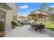 Expansive backyard featuring a patio with a dining set and lounge area, perfect for relaxation and entertainment at 5412 Hammock View Ln, Apollo Beach, FL 33572