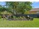 Serene backyard featuring a hammock, raised garden beds, and a cozy seating area, creating a peaceful outdoor oasis at 5412 Hammock View Ln, Apollo Beach, FL 33572
