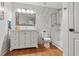 Bright bathroom featuring a marble tiled wall, white vanity, and a glass-enclosed shower at 5412 Hammock View Ln, Apollo Beach, FL 33572