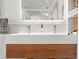 Modern bathroom vanity with a double sink and wood cabinets at 5412 Hammock View Ln, Apollo Beach, FL 33572