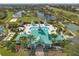Aerial view of a stunning community clubhouse with a pool, playground, and well-manicured grounds at 5412 Hammock View Ln, Apollo Beach, FL 33572