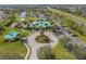 Beautifully landscaped community clubhouse featuring a circular drive and lush green spaces at 5412 Hammock View Ln, Apollo Beach, FL 33572
