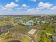 Aerial view of community park featuring a volleyball court, playground, pond, and walking trails at 5412 Hammock View Ln, Apollo Beach, FL 33572