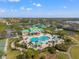 Aerial shot of community pool, clubhouse, and playground surrounded by lush landscaping and lakes at 5412 Hammock View Ln, Apollo Beach, FL 33572