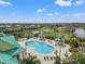 Aerial view of the community pool with covered seating, sundeck, and lush landscaping at 5412 Hammock View Ln, Apollo Beach, FL 33572