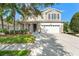Charming two-story home featuring a well-maintained lawn, a two-car garage, and a welcoming front porch at 5412 Hammock View Ln, Apollo Beach, FL 33572