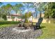 Inviting fire pit area with seating, set amongst a meticulously kept lawn, perfect for enjoying outdoor gatherings at 5412 Hammock View Ln, Apollo Beach, FL 33572