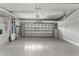 Spacious garage with overhead storage racks and epoxy flooring for organized parking at 5412 Hammock View Ln, Apollo Beach, FL 33572