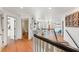 Upstairs hallway featuring wood flooring and access to the bathroom at 5412 Hammock View Ln, Apollo Beach, FL 33572