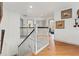 Hallway with wood floors leading to living spaces, neutral wall paint at 5412 Hammock View Ln, Apollo Beach, FL 33572