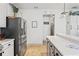 The kitchen features stainless steel appliances and a breakfast bar overlooking an adjacent room at 5412 Hammock View Ln, Apollo Beach, FL 33572