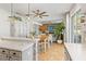 Bright, open kitchen with white cabinets, stainless appliances, and adjacent dining area at 5412 Hammock View Ln, Apollo Beach, FL 33572
