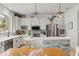 Bright and airy kitchen featuring stainless steel appliances, wine rack, and island with stone accents at 5412 Hammock View Ln, Apollo Beach, FL 33572