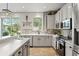 Well-lit modern kitchen boasts new stainless appliances, stone backsplash, and ample cabinet space at 5412 Hammock View Ln, Apollo Beach, FL 33572