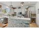 Contemporary kitchen featuring stainless steel appliances, island with seating, and pendant lighting at 5412 Hammock View Ln, Apollo Beach, FL 33572