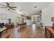 Open-concept living and dining area with tile floors, a decorative brick wall, and a staircase to the upper level at 5412 Hammock View Ln, Apollo Beach, FL 33572