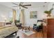 Bright main bedroom featuring a ceiling fan, sitting area, and hardwood floors at 5412 Hammock View Ln, Apollo Beach, FL 33572