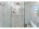 Modern walk-in shower featuring rainfall shower head and glass surround at 5412 Hammock View Ln, Apollo Beach, FL 33572