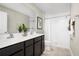 Bright bathroom featuring double sinks, a large mirror, and a walk-in shower at 629 171St E St, Bradenton, FL 34212