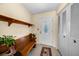 Inviting entryway featuring a wooden bench, shelving, and decorative glass front door at 6495 Fairlawn St, Spring Hill, FL 34606