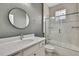 Bathroom featuring white vanity with round mirror, toilet, and shower-tub combo at 7399 Skylark Dr, Spring Hill, FL 34606