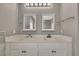 Bright bathroom featuring double sink vanity with quartz countertop and modern lighting at 7399 Skylark Dr, Spring Hill, FL 34606